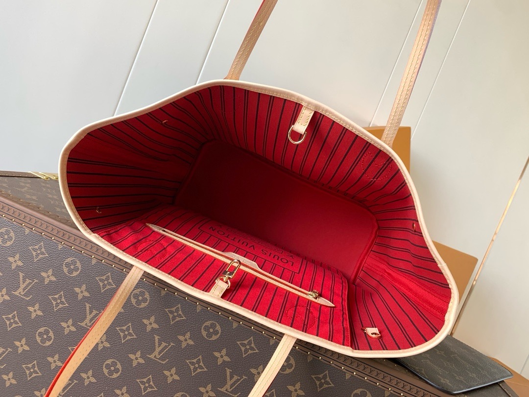 Open interior showing the cherry-red striped textile lining, flat zippered pocket and interior D-ring