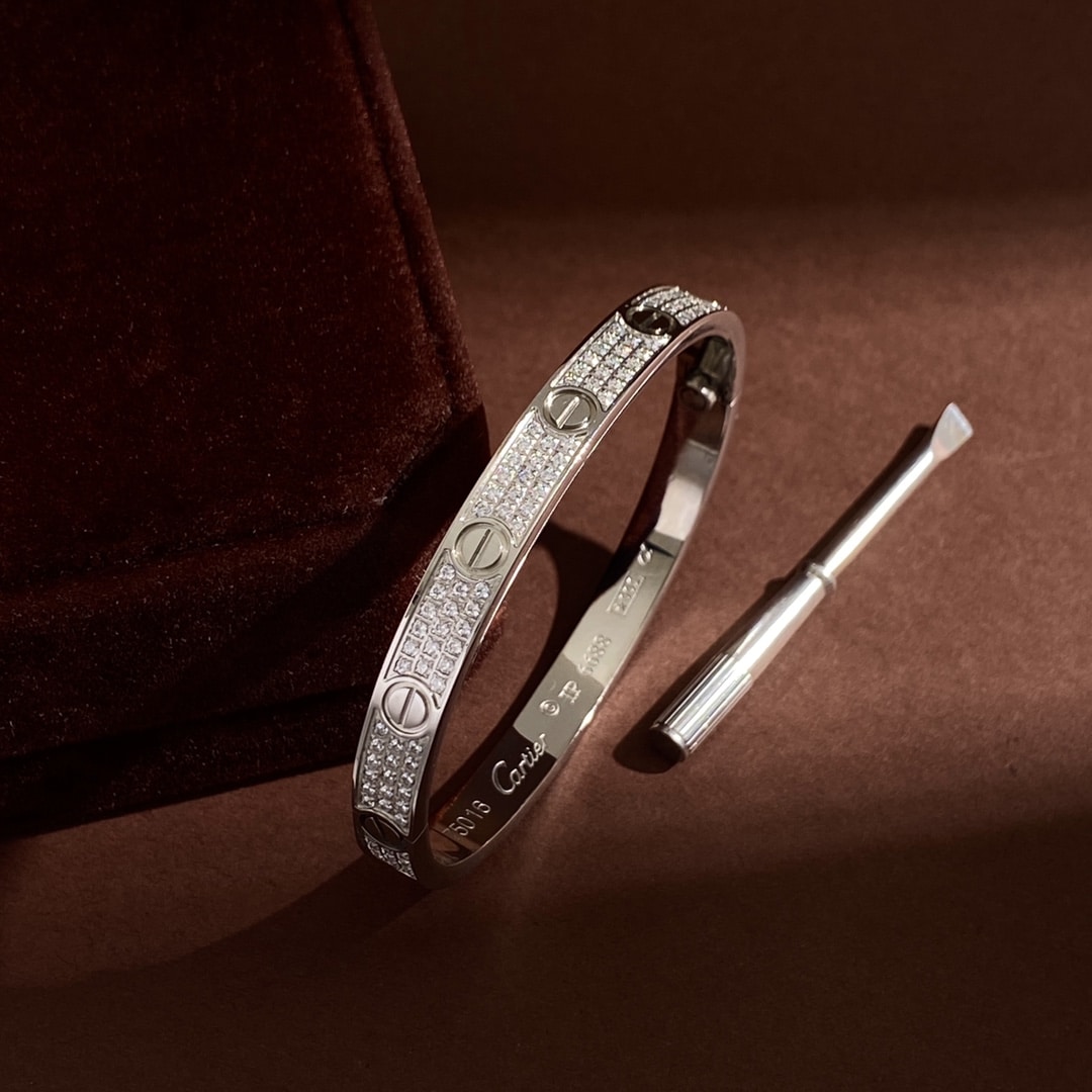 White gold Love Pavé bangle shown with its coordinating screwdriver