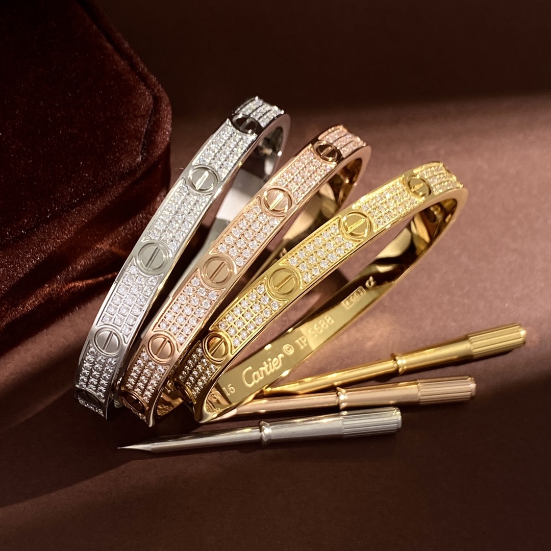 All three Love Pavé bangles stacked together in white, rose and yellow gold tones