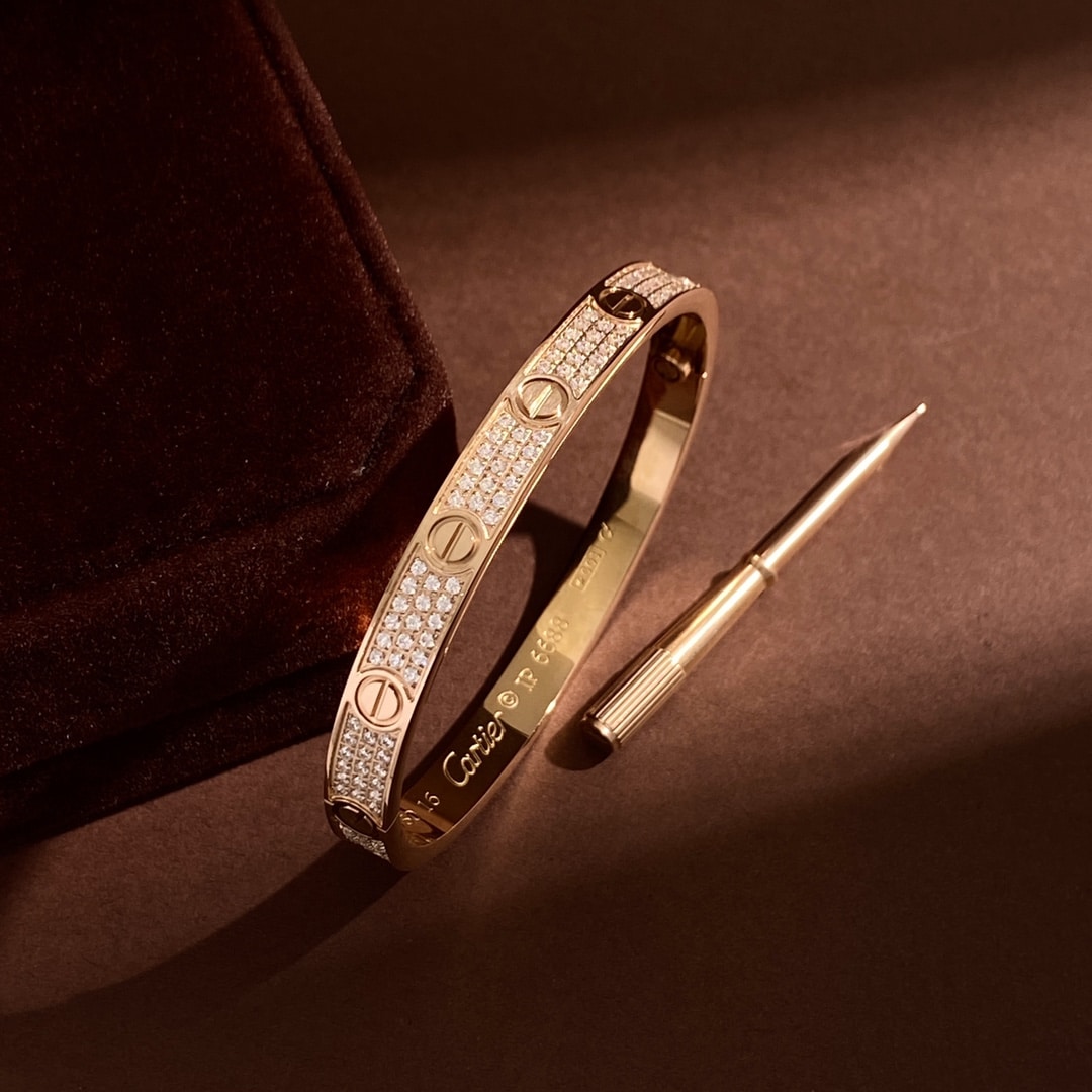 Rose gold Love Pavé bangle shown with its coordinating screwdriver