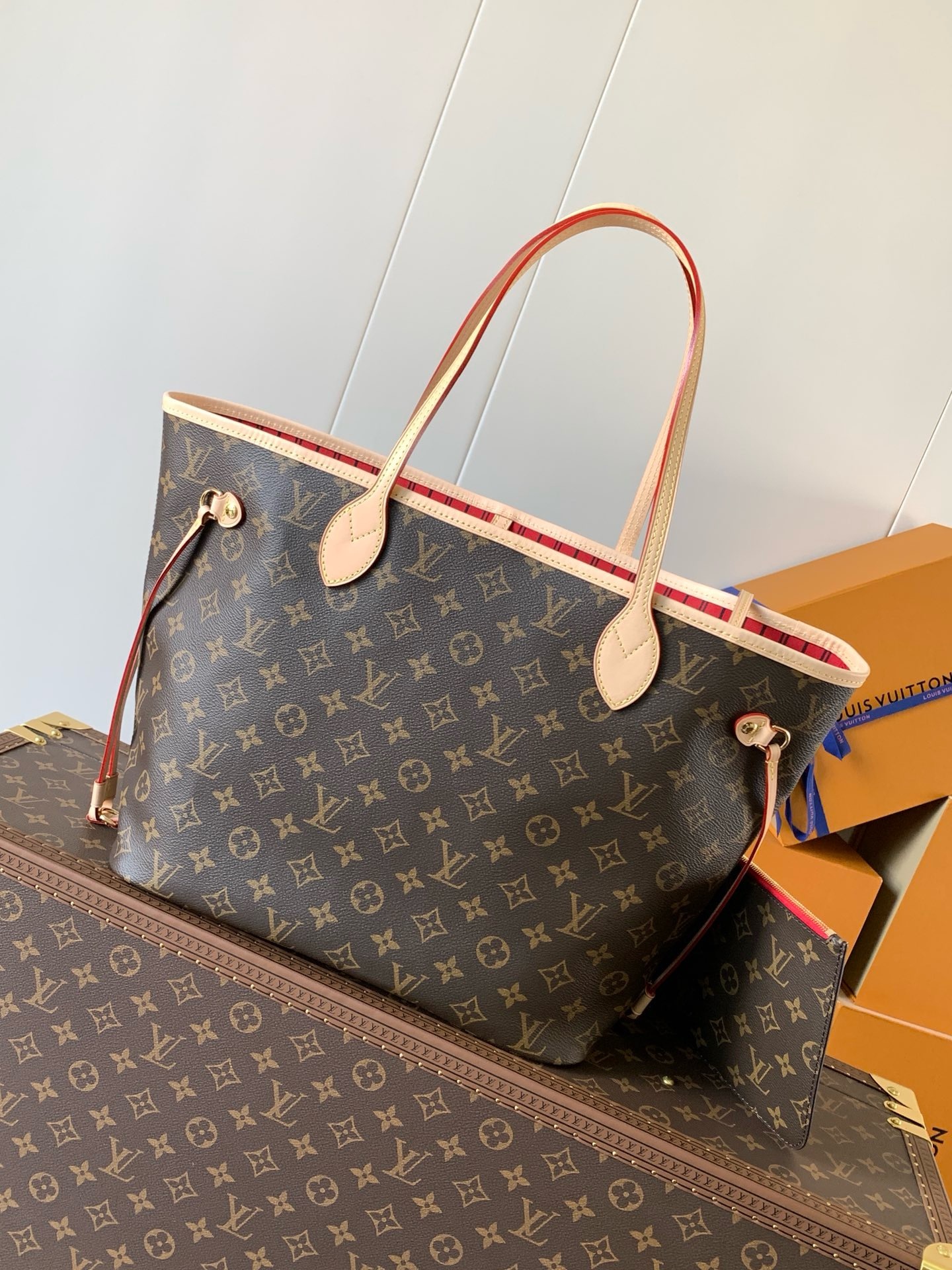 Alternate front view of the tote showing the cherry-red striped interior along the open top edge